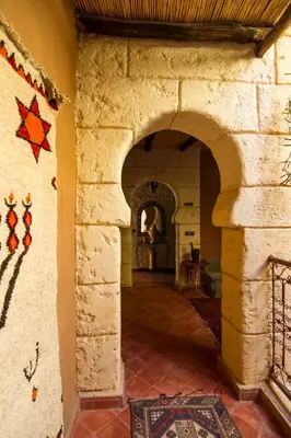 an archway in a building with a tile floor at Rose Noire in Ouarzazate