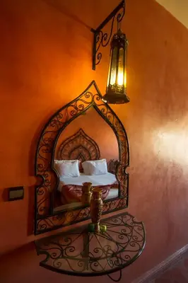 a bedroom with a mirror on the wall at Rose Noire in Ouarzazate