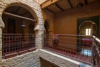 a balcony in an old building with red railing at Rose Noire in Ouarzazate