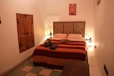 a bedroom with a bed in a room at Dar Rbab in Fès