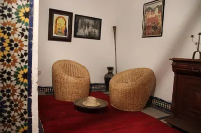 a living room with two chairs and a table at Dar Rbab in Fès