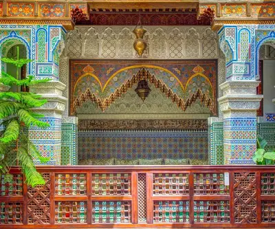 a wall of a building with colorful tiles at Riad Rcif & Spa Originale in Fès