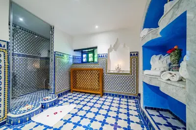 a bathroom with a blue and white tiled floor at Riad Rcif & Spa Originale in Fès