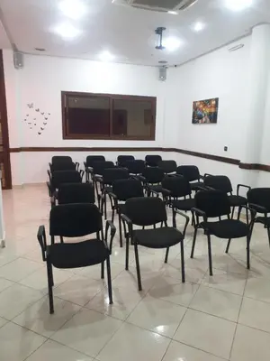 a class room with chairs and a projection screen at Perla Hôtel in Fès