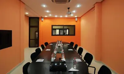 a conference room with a long table and chairs at Perla Hôtel in Fès
