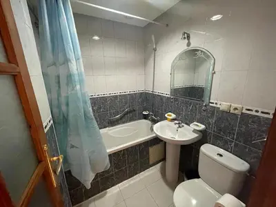 a bathroom with a toilet and a sink and a mirror at Perla Hôtel in Fès