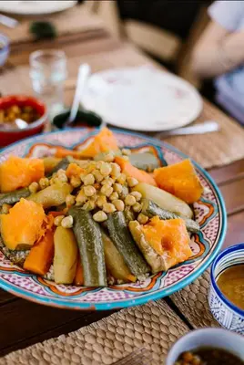 a plate of food with vegetables on a table at Riad Anata in Fès