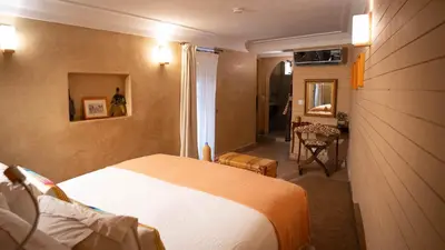 a hotel room with a bed and a table at Riad Anata in Fès