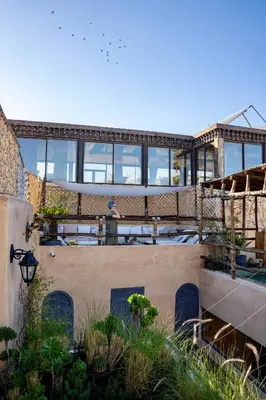 a man standing on the roof of a building at Riad Anata in Fès