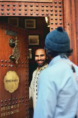 a man standing in front of a mirror at Riad Anata in Fès