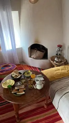 a living room with a table with food on it at Les Jardins du M'goun in Kalaat MGouna