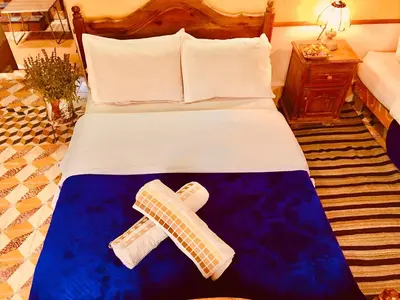 a hotel room with a bed with a cast on it at Hôtel panoramique de la vallée in Aït Idaïr