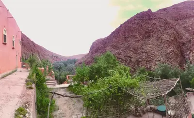 a view of a mountain next to a building at Hôtel panoramique de la vallée in Aït Idaïr