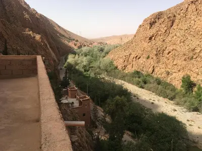a view of a village in a canyon at Hôtel panoramique de la vallée in Aït Idaïr
