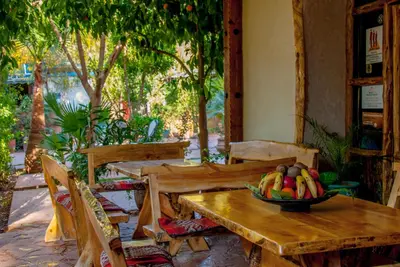 a bowl of fruit sitting on a wooden table at Hôtel Chellal ďOuzoud in Ouzoud