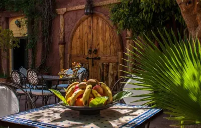 a bowl of fruit on a table in front of a door at Hôtel Chellal ďOuzoud in Ouzoud