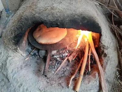 a mushroom is cooking in a fire oven at Auberge des lacs in Imilchil
