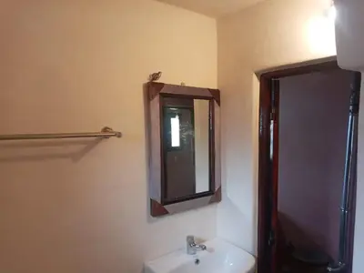 a bathroom with a sink and a mirror at Auberge des lacs in Imilchil