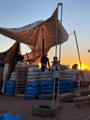 a group of people standing in front of a tent at Chez Madani in Mhamid