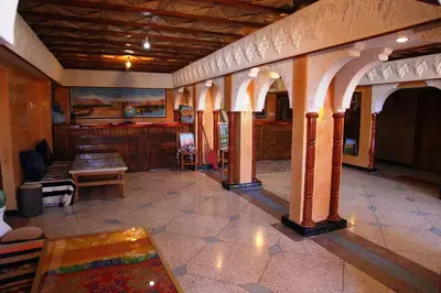 a room with a table and chairs in a building at La Kasbah De Dades in Boumalne