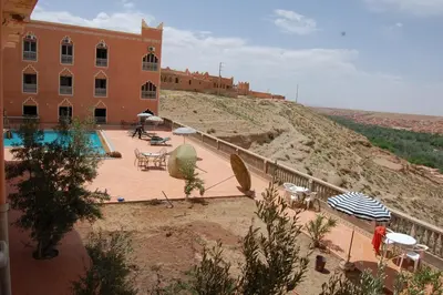 a building with a swimming pool next to a building at La Kasbah De Dades in Boumalne