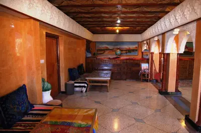 a room with a table and chairs in a room at La Kasbah De Dades in Boumalne
