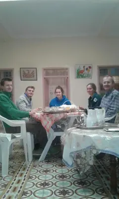 a group of people sitting around a table at Écologie oasis tafilalt CHEZ L' HABITANT in Er Rachidia