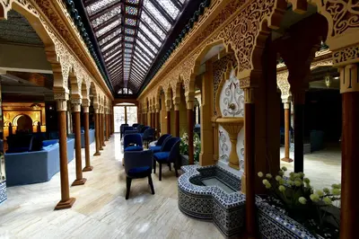 a row of chairs in a building with a ceiling at Hôtel Fès Inn & SPA in Fès
