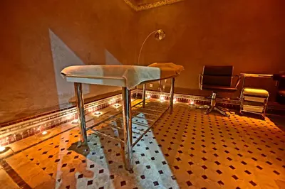a bar stool in a room with a table at Hôtel Fès Inn & SPA in Fès