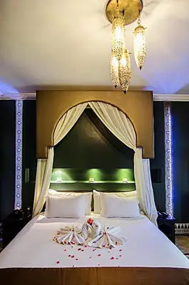 a bedroom with a large bed with candy canes on it at Palais Ommeyad Suites & Spa in Fès