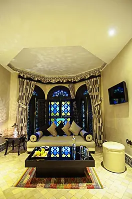 a living room with a couch and a window at Palais Ommeyad Suites & Spa in Fès