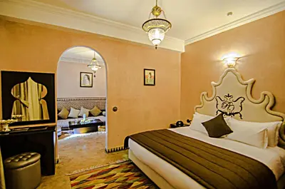 a hotel room with a bed and a mirror at Palais Ommeyad Suites & Spa in Fès
