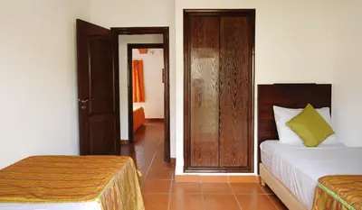 a bedroom with a bed and a door to a hallway at Farah Inn Ifrane in Ifrane