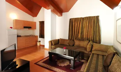 a living room with a couch and a tv at Farah Inn Ifrane in Ifrane