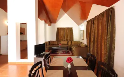 a living room with a table and a couch at Farah Inn Ifrane in Ifrane