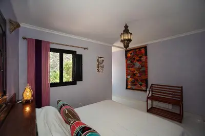 a living room with a couch and a window at Auberge le Maquis in Aghbalou