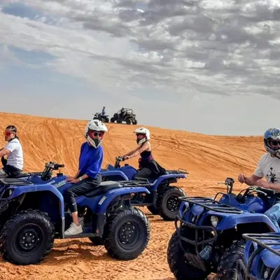 a group of people riding on atvs in the desert at Magic Luxury Camp in Merzouga