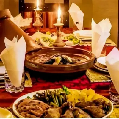 a table topped with plates of food on a table at Magic Luxury Camp in Merzouga