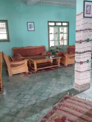a living room with a couch and a table at Complexe Collier D' Ambre in Imilchil