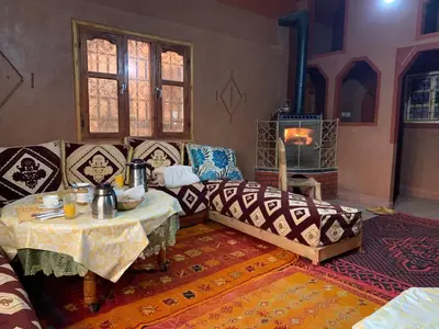 a living room with a couch and a table at Auberge Des Jardins du Dades in Boumalne