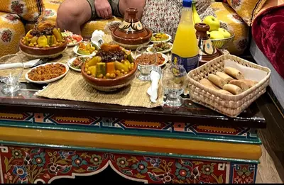 a table filled with different types of food on it at Dar Dahab in Fès