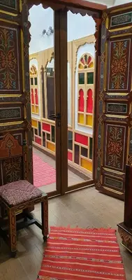 a room with a door and a bench in a room at Dar Dahab in Fès