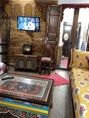 a living room with a couch and a tv at Dar Dahab in Fès