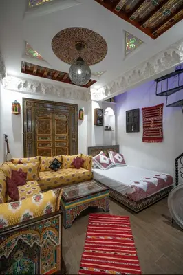 a living room with a couch and a bed at Dar Dahab in Fès