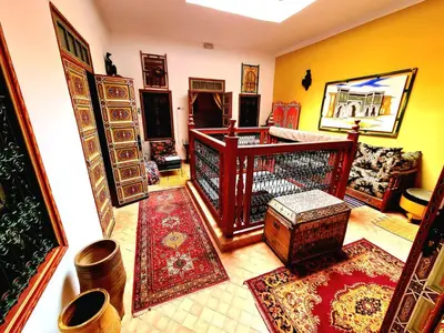 a living room filled with lots of rugs at Dar Pa Labzioui in Meknès