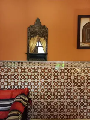 a mirror on the wall of a room at Dar Pa Labzioui in Meknès
