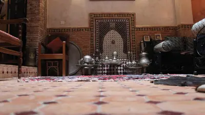 a room with a tiled floor and a fireplace at Dar Pa Labzioui in Meknès