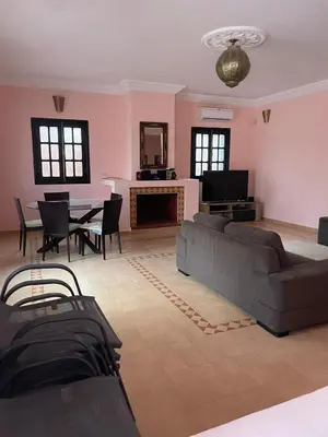 a living room with a couch and a table at Riad Marrakech Ourika in Marrakech
