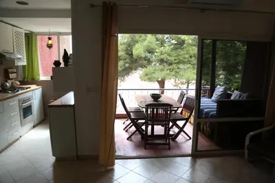a kitchen and living room with a table and chairs at Appart Bin Elouidane in Bine el Ouidane