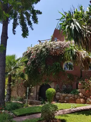 a house with a bunch of flowers on it at Appart Bin Elouidane in Bine el Ouidane